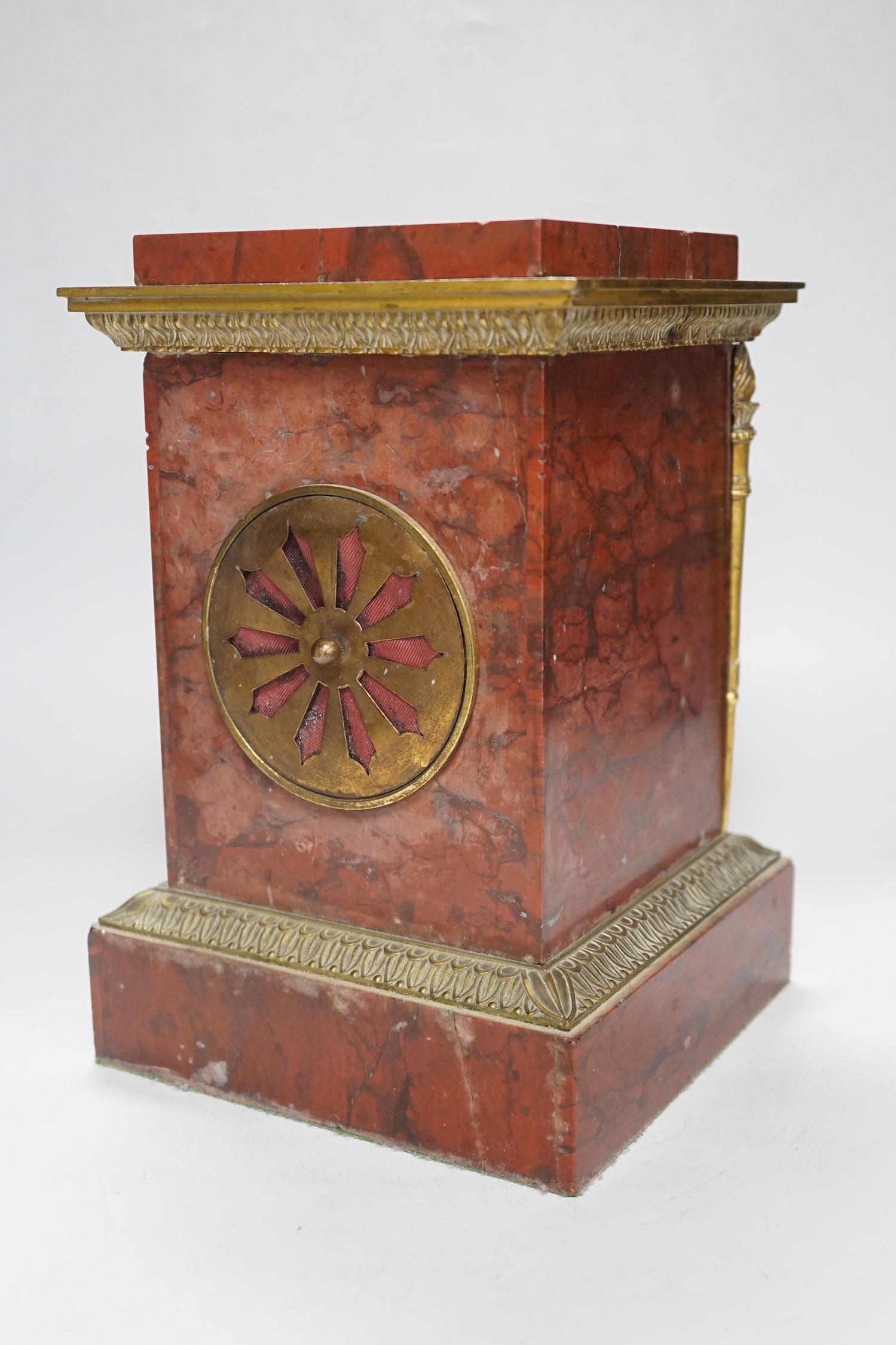 A French gilt metal mounted rouge marble mantel clock, first half 19th century, engine turned dial, 27cm high